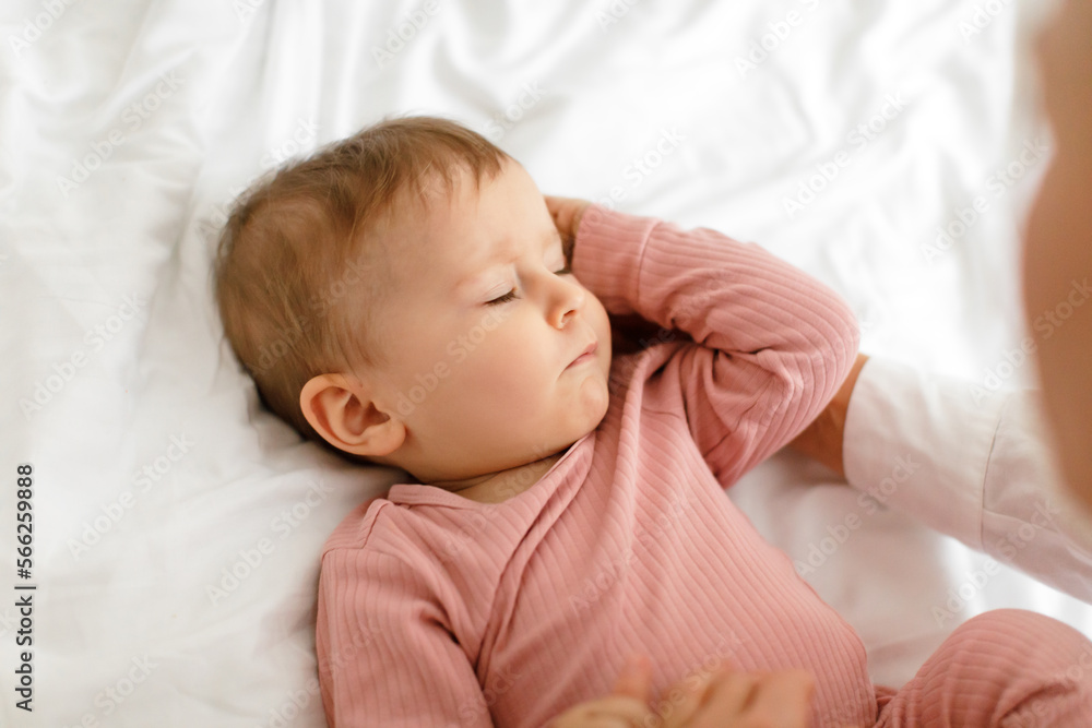 Daysleep concept. Closeup shot of cute little baby girl sleeping in bed, lying with closed eyes on white linens Daysleep concept. Closeup shot of cute little baby girl sleeping in bed, lying with closed eyes on white linens