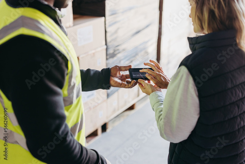 Female warehouse manager e-signing a dock receipt after receiving a delivery