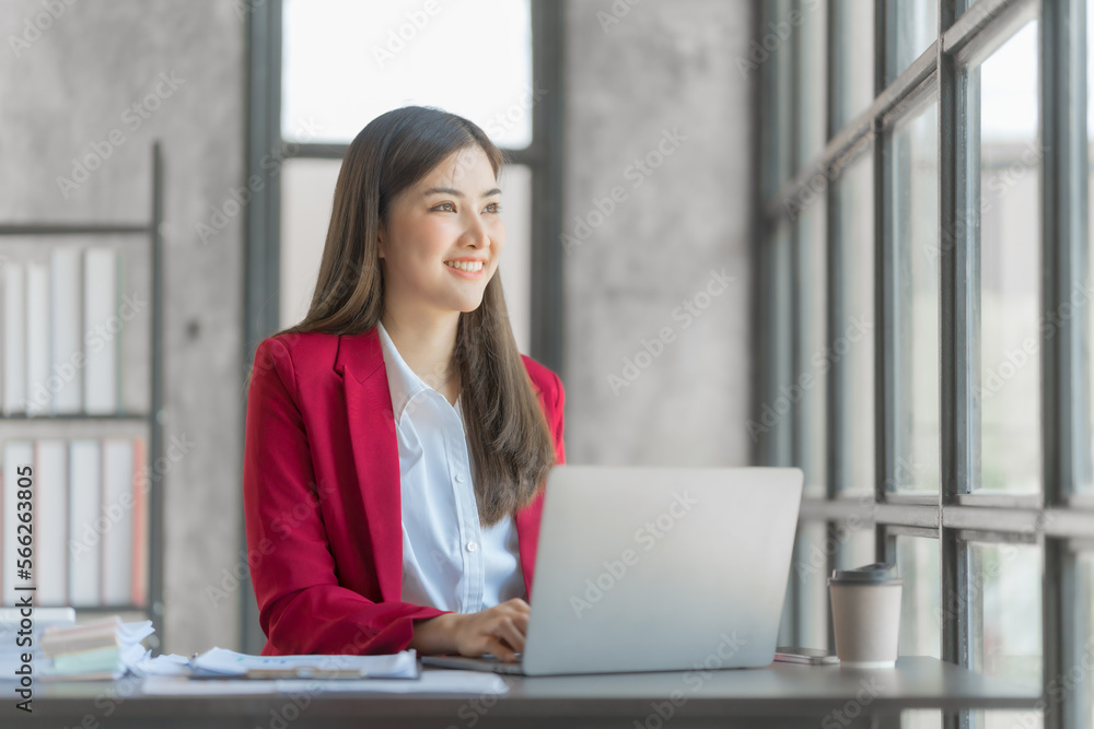 Beautiful asian accountant working with tablet computer in modern office with balance sheet, assets, stock market statistics, annual planning in office Beautiful asian accountant working with tablet computer in modern office with balance sheet, assets, stock market statistics, annual planning in office
