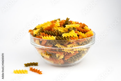 Italian fusilli paste in glass bowl isolated on white background. Close-up. Selective focus.