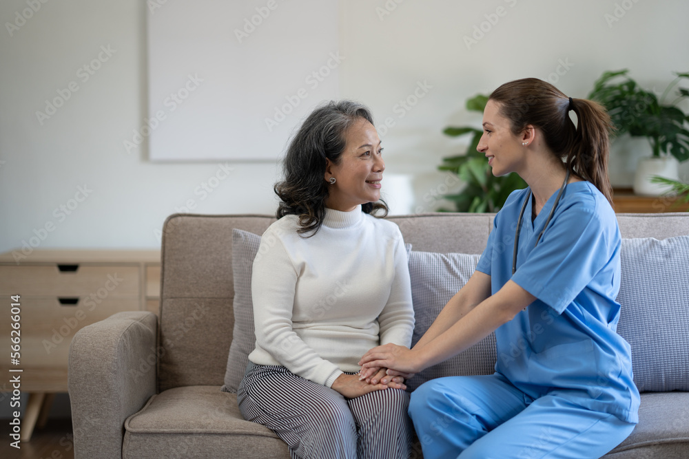 Young female physician leaning forward to elderly lady patient holding her hand in palms. supporting encouraging old person. Young female physician leaning forward to elderly lady patient holding her hand in palms. supporting encouraging old person.
