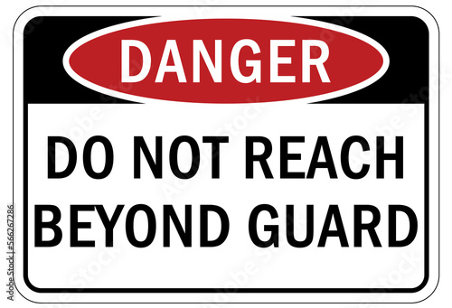 Machine guarding sign and labels do not reach beyond guard