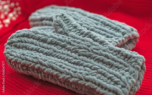Warm grey knitted gloves. Fashionable collection of accessories for women. Detail of wardrobe