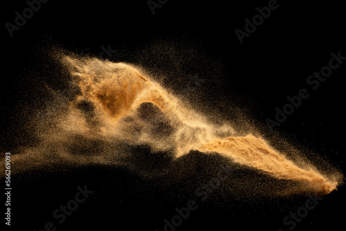 Dry river sand explosion.Brown color sand splash against black background.