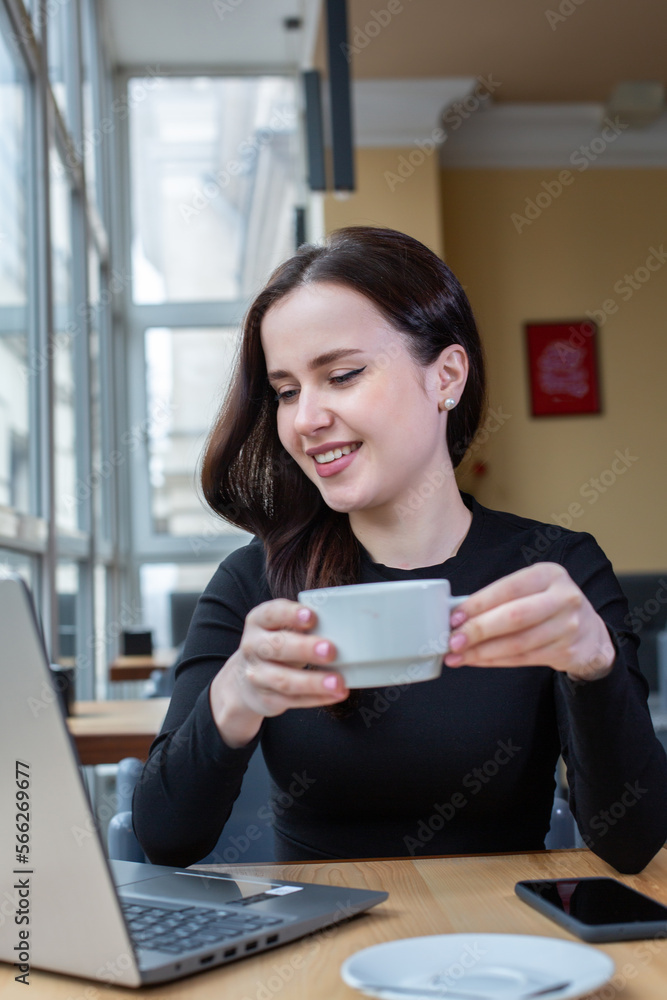 Beautiful businesswoman working on laptop in coffee shop. Female freelancer connecting to internet via computer. Blogger or journalist writing new article. Beautiful businesswoman working on laptop in coffee shop. Female freelancer connecting to internet via computer. Blogger or journalist writing new article.