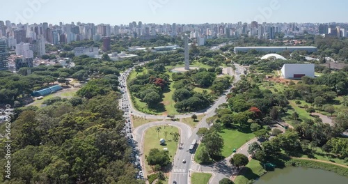 Entrance to Ibirapuera Park, obelisk in the background, intense vehicle traffic. Bottom-up reverse drone flight on sunny day