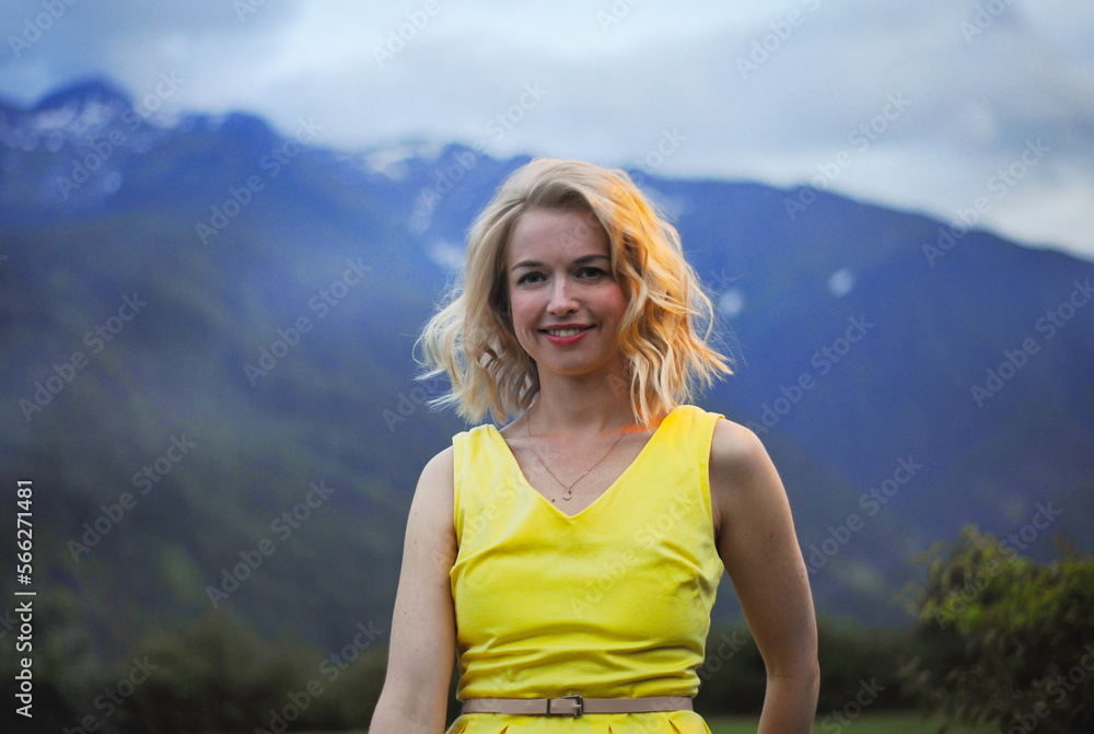 girl and a lantern in the twilight on the background of a mountain rural alpine landscape