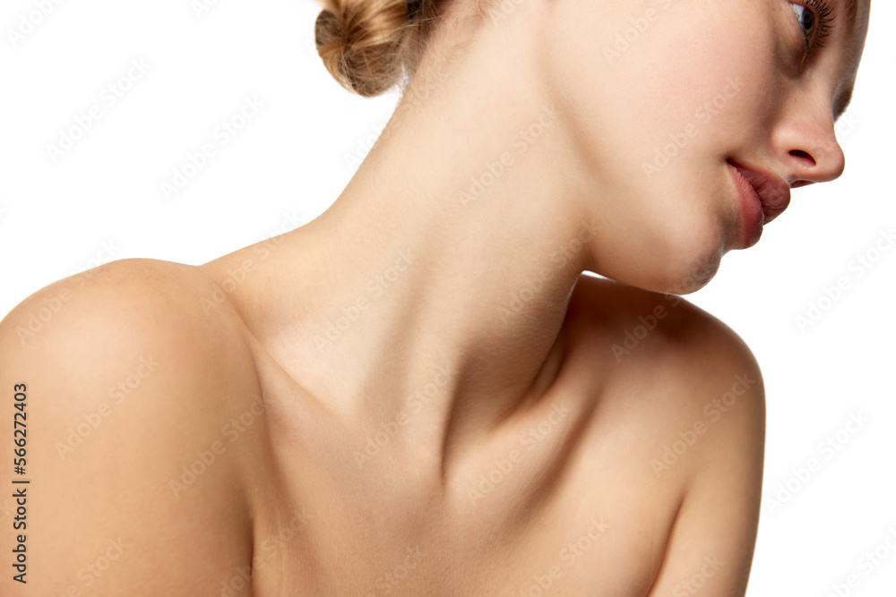 Cropped image of young beautiful woman with bare shoulders and slim long neck isolated over white studio background. Cropped image of young beautiful woman with bare shoulders and slim long neck isolated over white studio background.