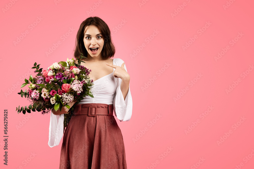 Glad young caucasian lady in casual with open mouth, show finger at herself, hold bouquet of flowers Glad young caucasian lady in casual with open mouth, show finger at herself, hold bouquet of flowers