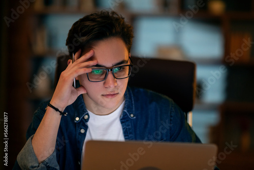 Young businessman working overtime alone in an office