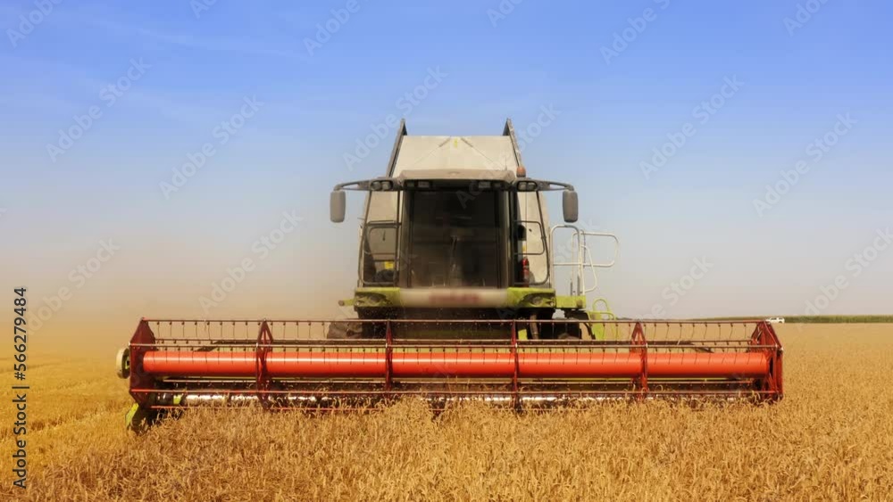 Yield combining within the field with a skyline behind. Aerial view of agricultural machinery on a harvest season. High quality 4k footage Yield combining within the field with a skyline behind. Aerial view of agricultural machinery on a harvest season. High quality 4k footage