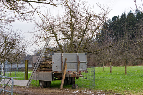 Farm with meadow, trailer and orchard on a gray cloudy winter day at City of Zürich district Schwamendingen. Photo taken January 29th, 2023, Zurich, Switzerland.