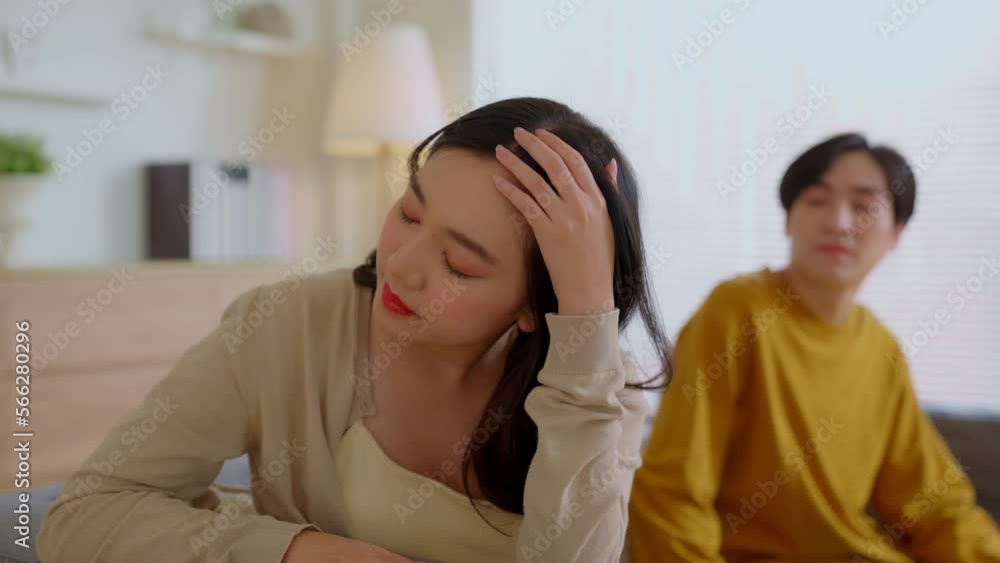 Asian couple sit separate on couch having relationships problems, stressed upset .Asia husband and wife avoid talking, sad man and woman think of divorce or breakup. Disappointed and saddened Asian couple sit separate on couch having relationships problems, stressed upset .Asia husband and wife avoid talking, sad man and woman think of divorce or breakup. Disappointed and saddened