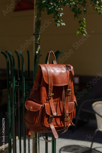 Orange leather oldfashioned backpack on a metal grid