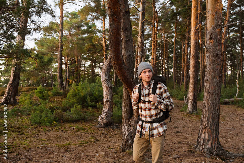 Young smiling active man tourist hiking in forest Young smiling active man tourist hiking in forest
