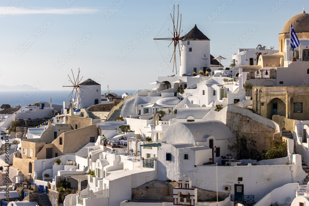 Fototapeta premium Whitewashed houses and windmills in Oia on Santorini island, Cyclades, Greece