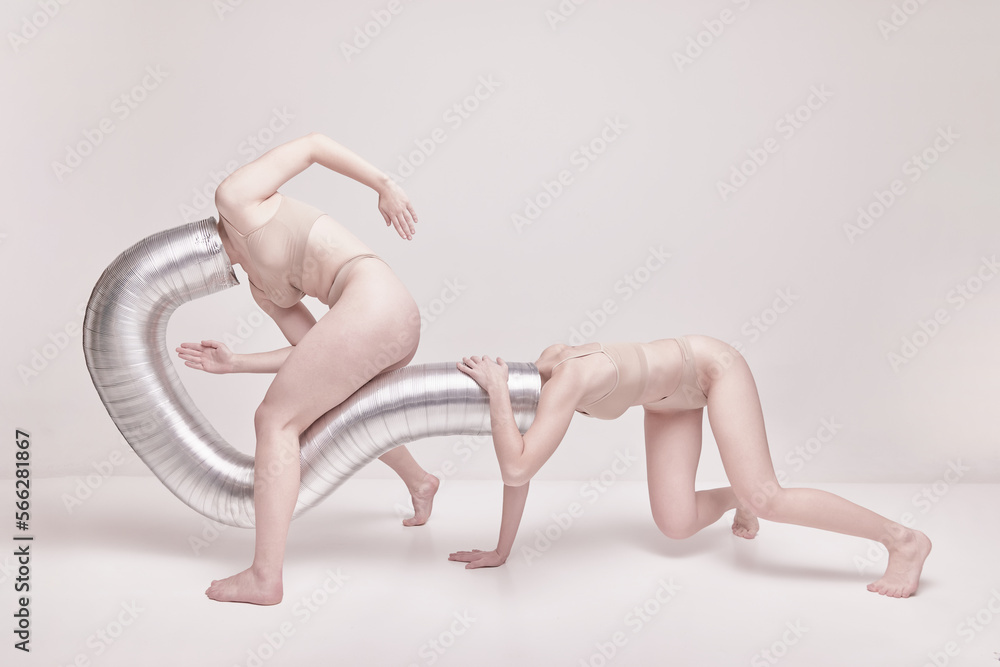 Contemporary style. Creative photography with two young girls posing in nude  underwear over beige studio background. Concept of cringe, queer, art  photography, weird people, creativity Stock Photo