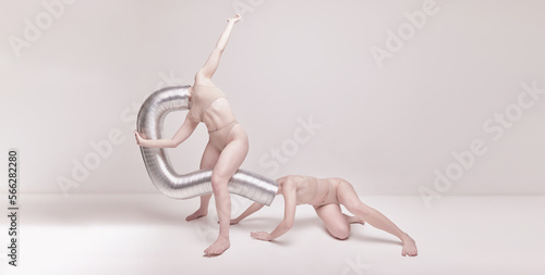 Creative photography with two young girls posing in nude underwear over beige studio background. Banner. Concept of cringe, queer, art photography, weird people, creativity photo