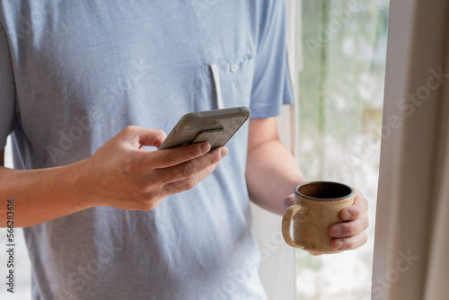 Close up hand of man using smartphone .Display mockup close up over shoulder view..