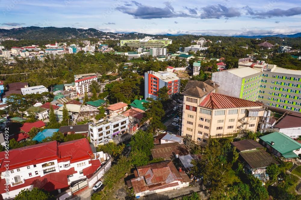 Baguio City, Philippines - Afternoon drone aerial of the Baguio skyline, with Burnham Park and SM Baguio in the distance.