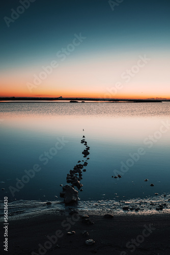 Outdoors lake at sunset. Soft sunlight  glowing pink and golden clouds  reflection in a crystal clear water. Idyllic landscape. Panoramic view. Nature  ecology  ecotourism. Peace and joy concepts