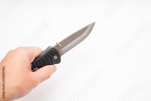 Hand holding a hunting knife on a white background photo