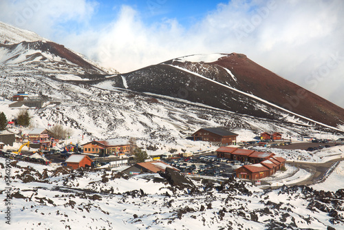 Etna in inverno - vacanze  e mete turistiche in Sicilia e il panorama innevato sui crateri Silvestri durante giornata di sole e cielo blu photo