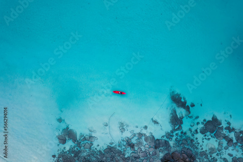 Top view of happy tourist canoeing on turquoise sea in summer at tropical island