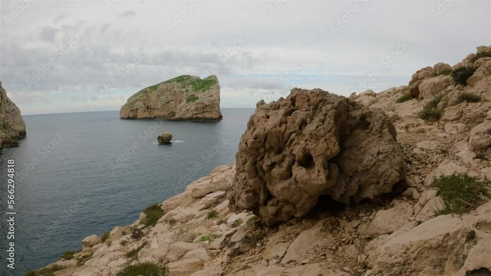 View of Rocky Coast with Cliffs on the Mediterranean Sea. Regional Natural Park of Porto Conte, Sardinia, Italy. Nature Background. Slow Motion Cinematic View of Rocky Coast with Cliffs on the Mediterranean Sea. Regional Natural Park of Porto Conte, Sardinia, Italy. Nature Background. Slow Motion Cinematic