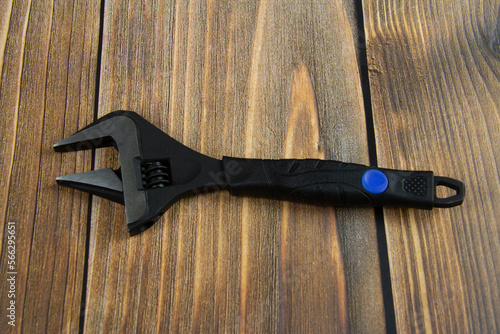 Wrench on a wooden surface. Repair tool