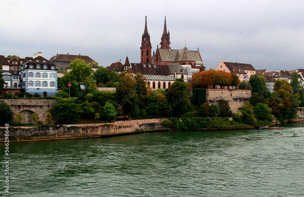 View of the Gothic red brick Basel Cathedral and the embankment of the Rhein River in the city of Basel, northern Switzerland	