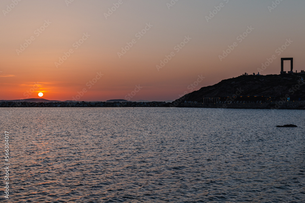 Naxos sunset with the Portara or Temple of Apollo in distance Naxos sunset with the Portara or Temple of Apollo in distance