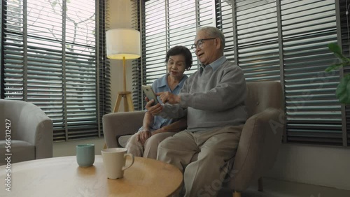 Happy Retired couple family spouses having fun use smartphone at home