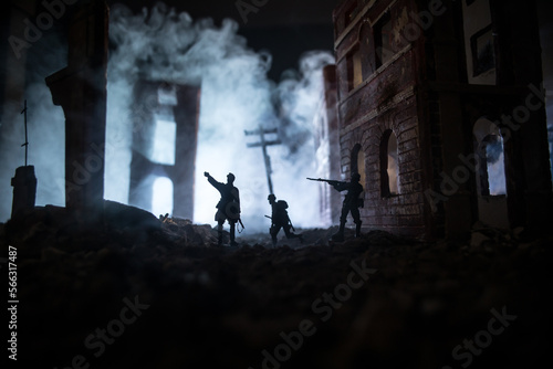 War Concept. Military silhouettes fighting scene on war fog sky background, World War Soldiers Silhouette Below Cloudy Skyline At night. Battle in ruined city.