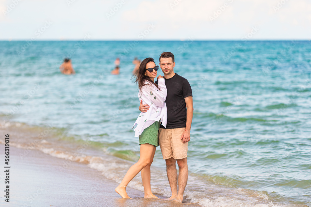 Young couple on white beach during summer vacation.