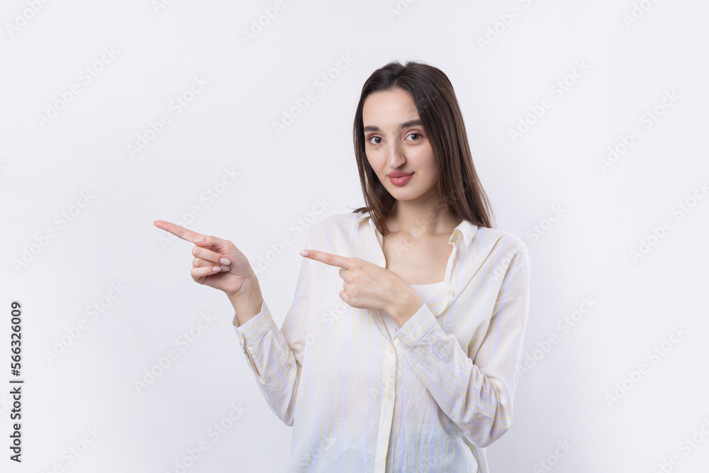 Happy young caucasian female in a shirt pointing fingers away Happy young caucasian female in a shirt pointing fingers away