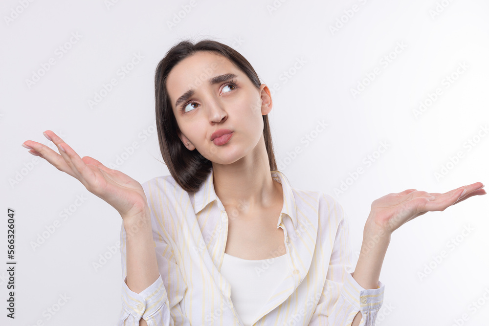 Young beautiful woman with facial expression of surprise standing over white background. Young beautiful woman with facial expression of surprise standing over white background.
