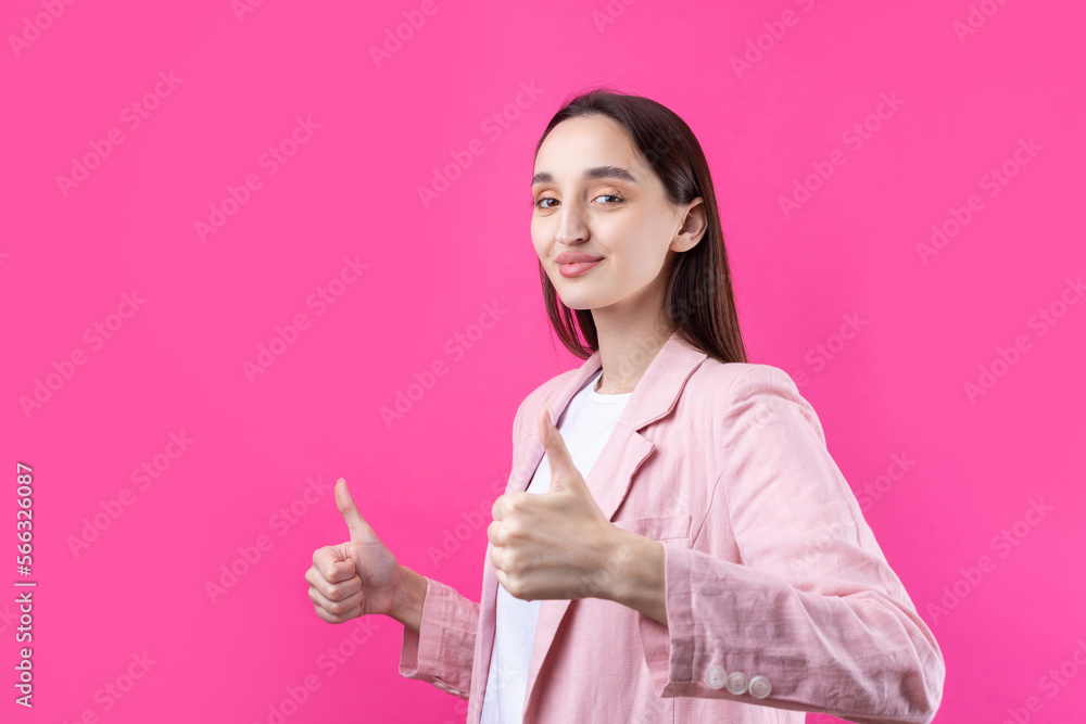 Happy young caucasian female in an pink jacket making thumb up sign and smiling. Good job and respect. Happy young caucasian female in an pink jacket making thumb up sign and smiling. Good job and respect.