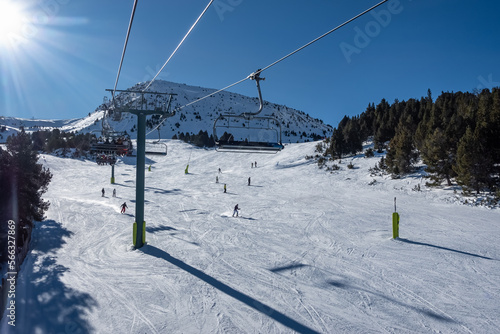 Panoramic view of a ski slope in the Pyrenees in Andorra, on sunny day and blue sky. © josemiguelsangar