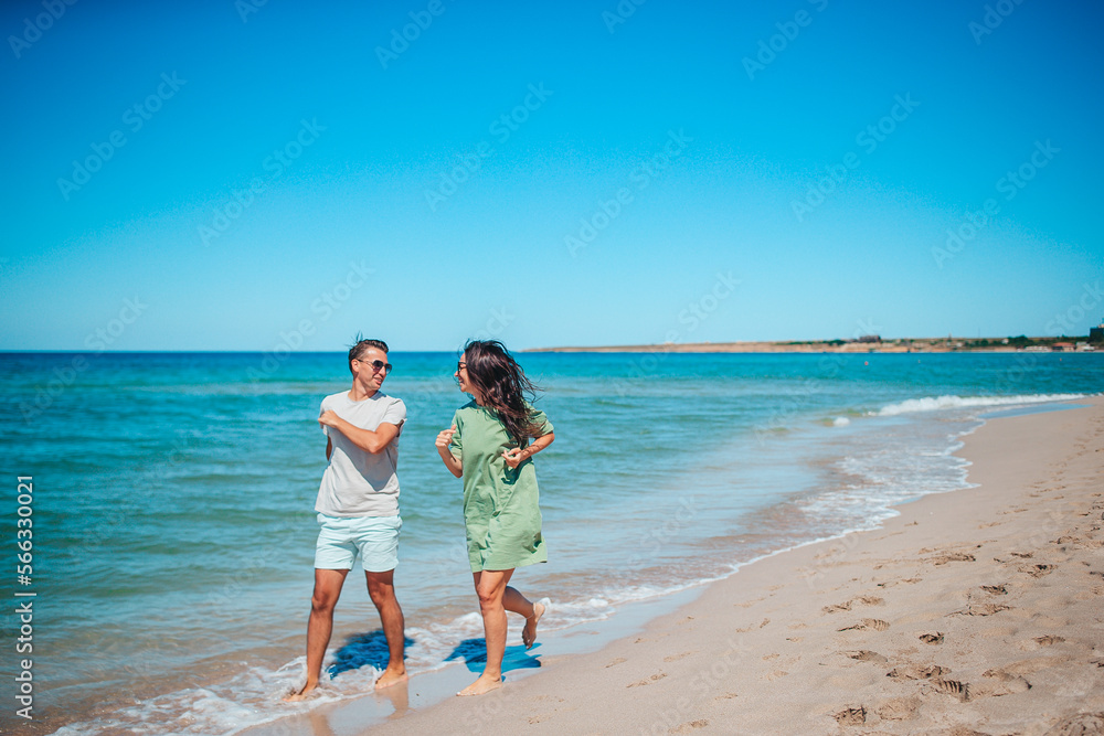 Young couple on white beach during summer vacation. Young couple on white beach during summer vacation.