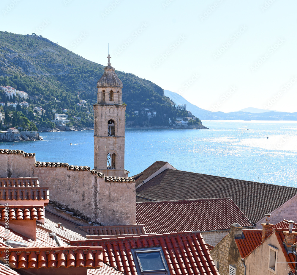 Fototapeta premium slim tower above the Dominican Monastery with classic red tiled rooftops inside the old town of Dubrovnik, Croatia 