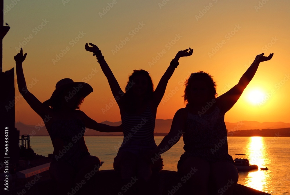 women in a sunset on the beach
