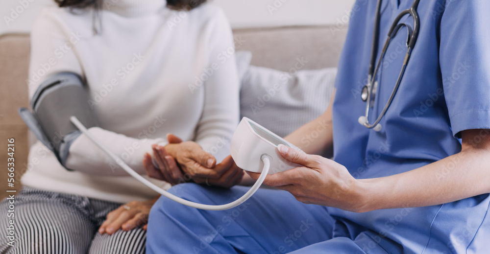 Obraz premium Homecare nursing service and elderly people cardiology healthcare. Close up of young hispanic female doctor nurse check mature caucasian man patient heartbeat using stethoscope during visit