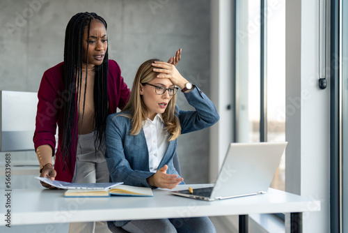 Vászonkép Two business women company female managers having problems with laptop system being hacked stopped working lost internet connection in middle of important work, feeling frustrated over deleted data