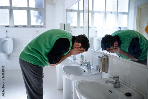 young boy exploring different emotions in front of the mirror