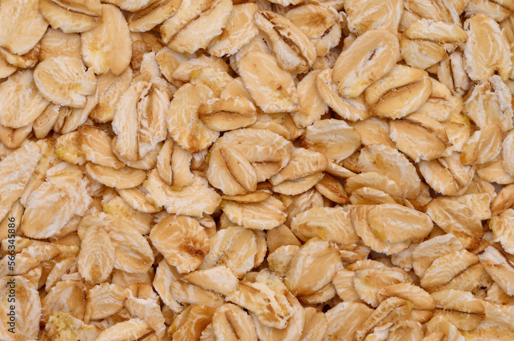 Macro photo of oatmeal. Texture, background of dry oatmeal.Healthy, delicious food, source of amino acids,minerals. Macro photo of oatmeal. Texture, background of dry oatmeal.Healthy, delicious food, source of amino acids,minerals.