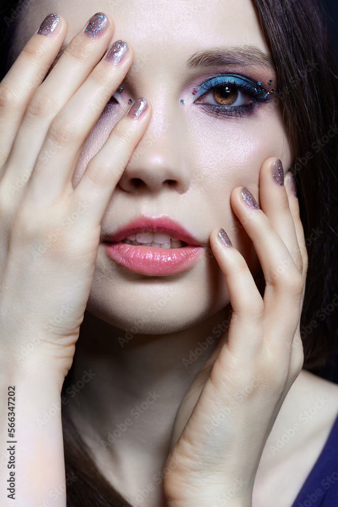 Close-up portrait of beautiful brunette with blue eye shadow make up and rhinestones. Close-up portrait of beautiful brunette with blue eye shadow make up and rhinestones.