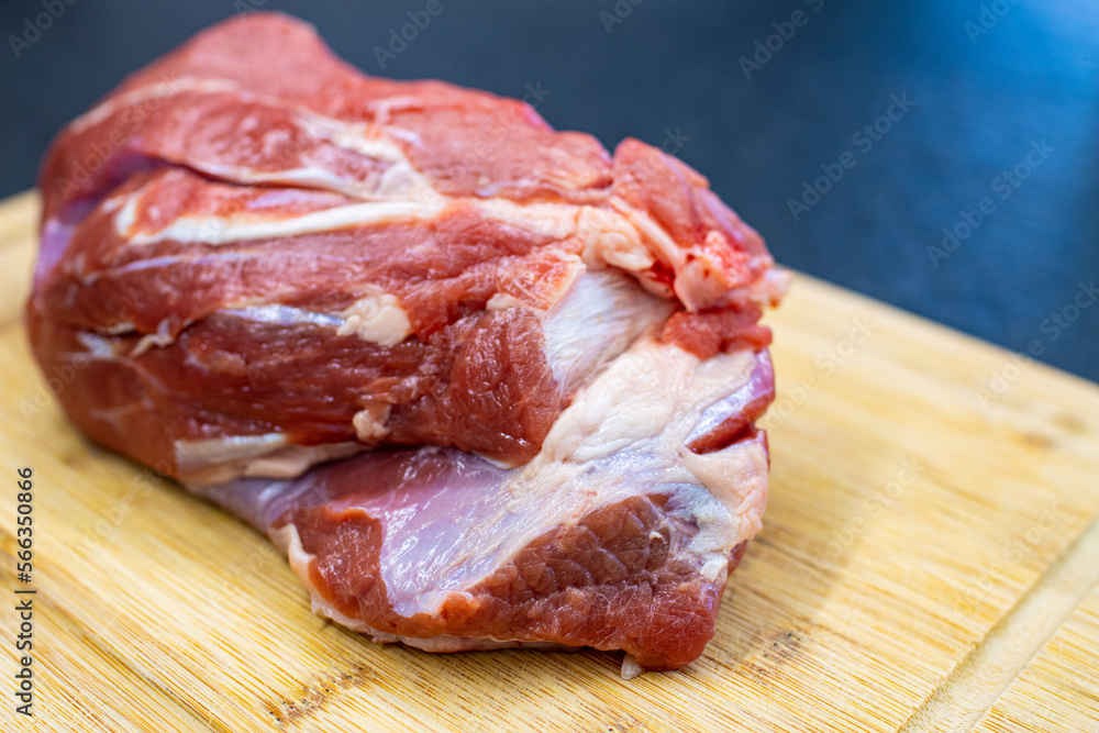 raw beef shoulder on a cutting board. Meat to be boiled in tradional italian dish 