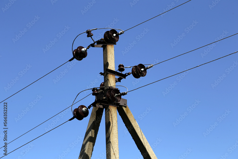 An electric pole with wires, insulators and cables An electric pole with wires, insulators and cables