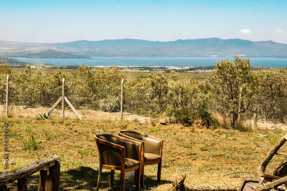 Chairs under the tree on a fire place in the wild against the background of Lake Naivasha in Rift Valley, Kenya Chairs under the tree on a fire place in the wild against the background of Lake Naivasha in Rift Valley, Kenya